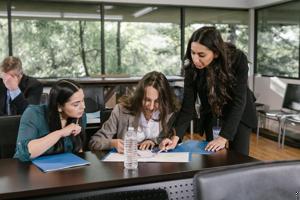 A group of women looking at a piece of paper