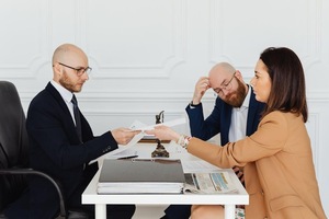 A person handing over a paper to a person