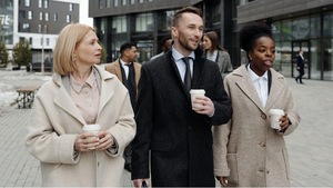 A group of people walking down the street