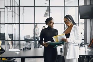 Two professional women standing in an office